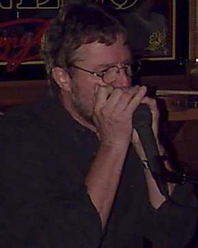 this is a picture of Steve Linde playing his harp